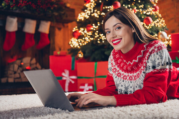 Wall Mural - Photo of adorable positive lady lying floor using modern device order courier delivery holiday dinner enjoy winter time house indoors