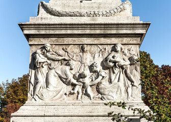 Wall Mural - Marble pedestal with bas reliefs of the monument to St Francis of Assisi in Risorgimento Square, built in early 20th century, Milan, Lombardy region, Italy