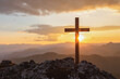 Silhouettes of crucifix symbol on top mountain with bright sunbeam on the colorful sky background