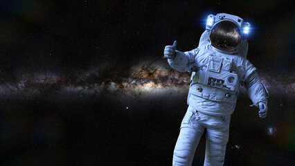 Wall Mural - astronaut showing thumbs up sign during spacewalk