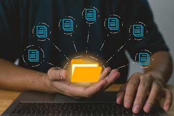 Leinwandbilder - Businessman holding folder and document icon software, searching and managing files in online document databases for efficient archiving and company data.