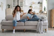 © DimaBerlin - Emotional anxious young woman mother arguing, swearing by phone in front of child at home, unhappy upset teen girl daughter listening her parent mom talking with school teacher about bad grades