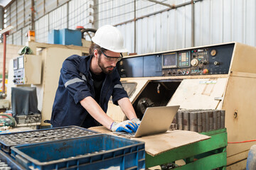 Aufkleber - Male engineer worker working with laptop computer for control machine in the workshop. Male worker working with lathe machine with safety uniform, goggles and helmet in the industry factory