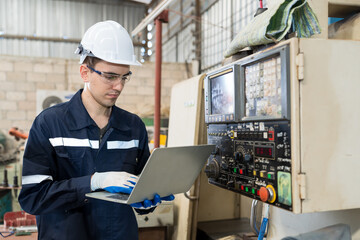 Aufkleber - Male engineer worker working with laptop computer for control machine in the workshop. Male worker working with lathe machine with safety uniform, goggles and helmet in the industry factory