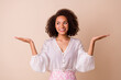 © deagreez - Photo of nice positive lady look hands palms demonstrate empty space isolated on beige color background