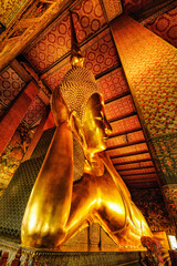 Wall Mural - famous golden reclining buddha statue in Buddhist temple at wat pho in Bangkok Thailand