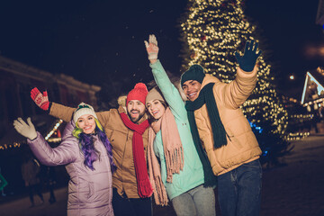 Poster - Portrait of group funny excited buddies arms waving hi have good mood x-mas evening lights outdoors