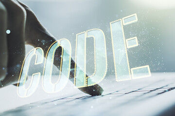 Wall Mural - creative code word sign and hands typing on laptop on background, international software development