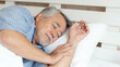 © suphaporn - Senior male , old man  sleeping on bed in the morning - lifestyle senior male concept