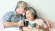 © suphaporn - senior couple happy love Elderly couple smile face, old man and senior woman relaxing in bed room drinking coffee in the morning  - lifestyle senior love couple healthy concept