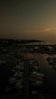 Vertical aerial shot of a boat harbor at sunset