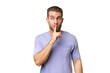 © luismolinero - Young handsome caucasian man isolated on green chroma background showing a sign of silence gesture putting finger in mouth