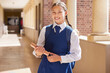 © L Ismail/peopleimages.com - Portrait girl, education and school, book and happy smile in uniform, scholarship and start studying, back to school and bag. Student, knowledge and ready to learn, high school and notebook on campus