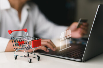 Man using laptop for shopping online on virtual screen icon with hand hold credit card. shopping cart, e-commerce, internet banking, spending money concept , purchase product sale.