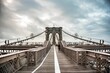 Scenic display of tourists walking along the Brooklyn bridge skyline against a cloudy sky, USA