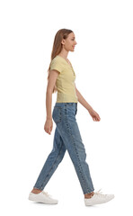 Wall Mural - Young woman in casual outfit walking on white background