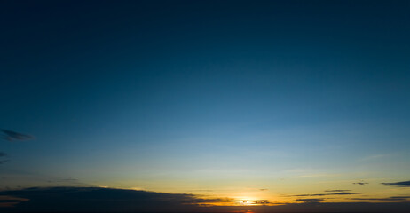 Dramatic golden and dark blue sunset sky abstract background. Dark blue sky in the evening. Sky at dusk. Sunset abstract background. Dusk and dawn concept. Beauty in nature.Majestic sky for wallpaper.
