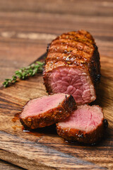 Wall Mural - Closeup view of roasted beef brisket flat steak on wooden cutting board