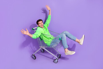 Poster - Full length photo of funny excited guy dressed neon sweatshirt shopping tray rider isolated violet color background