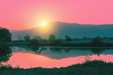 Poster - Mountain landscape in the evening. Beautiful lake against mountains. The Hula Valley in northern Israel at sunset