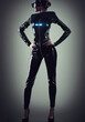 © Martin - Cyberpunk woman with skintight suit wearing VR glasses concept of future.