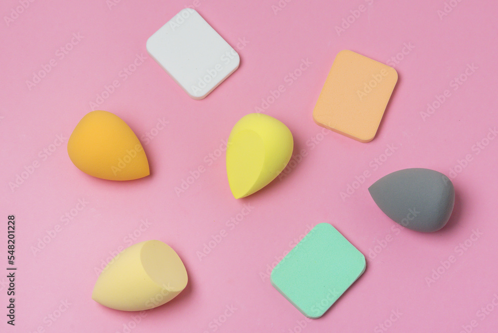 Colored Make up Egg Make up Sponge Puff make up Ugg Makeup Tool Concept Pink Background