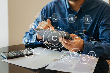 Wall Mural - Copyright or patent concept, Person hand using laptop computer, tablet and smartphone with virtual screen copyright icon trademark, Creation ownership against piracy.