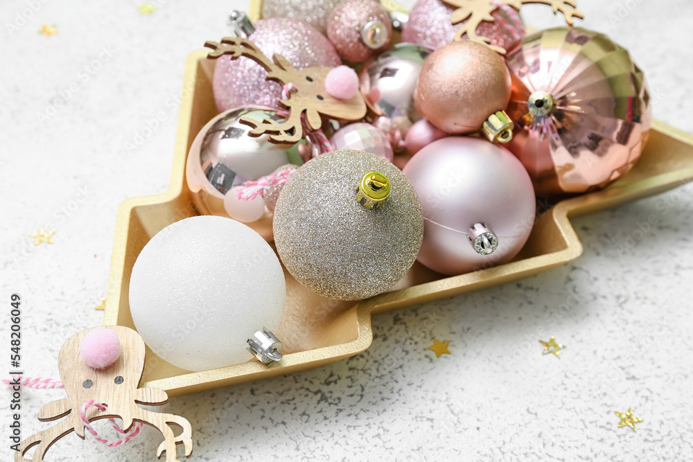 Plate in shape of Christmas tree and decor on white background, closeup