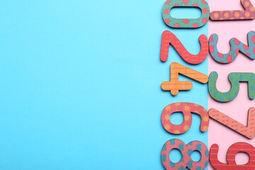 Wall Mural - Wooden numbers on colorful background, flat lay. Space for text