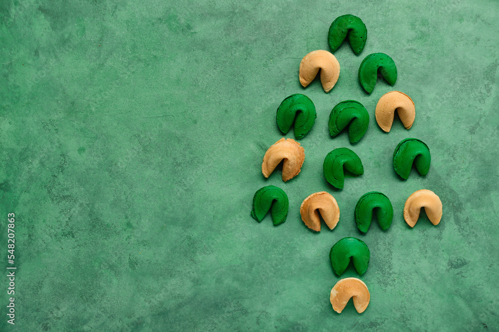 Christmas tree made of fortune cookies on green background