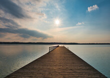 Late Afternoon Over A Pier. Blue And Orange Sky Over A Lake. Late Afternoon Over A Lake Side.