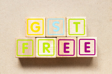 Poster - Color letter block in word GST (Abbreviation of Goods and Services Tax) free on wood background