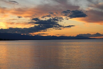 Sticker - Scenic view of a calm coast during sunset