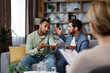 © YURII MASLAK - A family psychologist conducts a session in a beautiful office. LGBT couple at a psychotherapist's appointment. Psychologist for gays. Support for the LGBT community in visiting a psychologist.