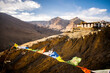 View of colorful fabrics before the buildings in Spiti Valley under the sunlight