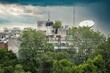 Landscape of residential buildings surrounded by trees on a stormy day in Delhi, India
