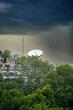 Vertical shot of residential buildings surrounded by trees on a stormy day in Delhi, India
