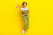 © deagreez - Full length photo of attractive young bob brown hair girl hold fishnet stick look empty space dreaming how catch isolated on yellow color background