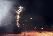 Image Of Gold Trophy With Sparkly Overlay Over Dark Background