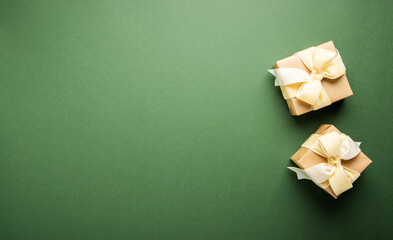 Wall Mural - gifts with yellow ribbon, present on green background top view. valentine's day. birthday. women's d