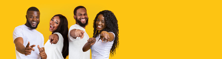 African american young people pointing at camera and smiling