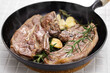 lamb shoulder chop steaks on a skillet
