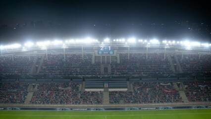 Wall Mural - Football Soccer Stadium Championship Match, Scoreboard Screen Showing Score of 2:1. Crowd of Fans Cheering, Happy, Having Fun. Sport Channel Television Advertising Playback Concept