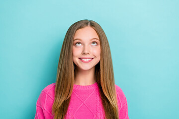 Poster - Portrait of optimistic adorable positive girl with long hairdo wear pink pullover look empty space isolated on blue color background