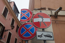 Rome, Italy: quirky street art by French street artist, Clet, on a no entry road sign in Trastevere. Black stick man carries white bar on red circle.