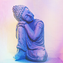 Buddha Resting Head On Knee. Is Originally Meant For The Garden, But Got Damaged By Frost. The Shoulder Is Repaired. Blue Light Is Been Used To Create A Blue Glow
