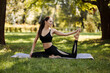 © Ankor_stock. - Young woman in sportswear doing leg stretching in the city park.
