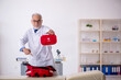© Elnur - Old male paramedic working in the clinic