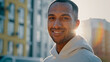 © Yuliia - Close up male portrait in morning sun rays young athletic handsome afro american latino guy stand on city street alone successful millennial sportsman looking at camera smiling enjoy healthy lifestyle