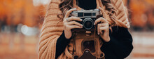Girl Holding An Old Camera In Her Hand